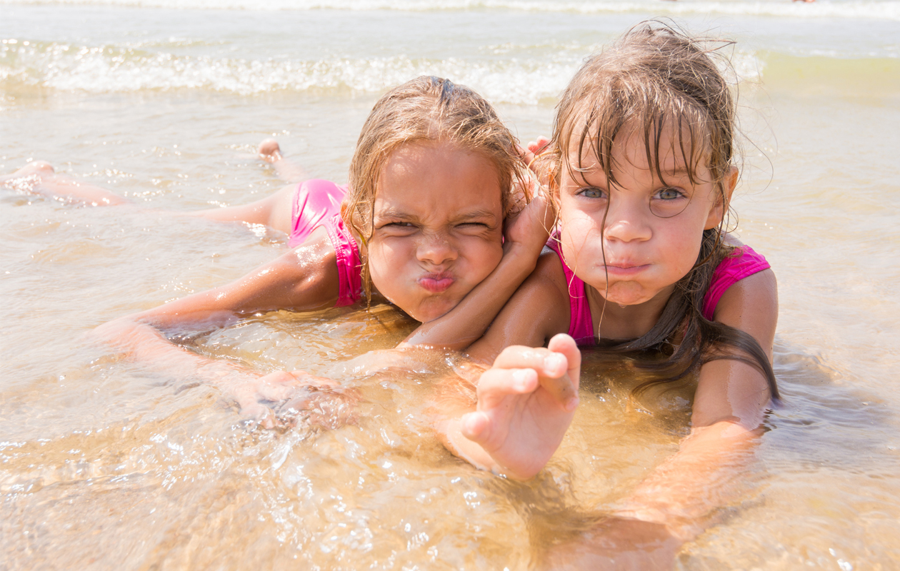kaksi tyttöä uimassa ranta aurinko
